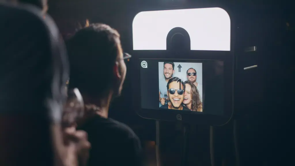 Guests discovering their photo on a sharingbox photo booth screen at an event