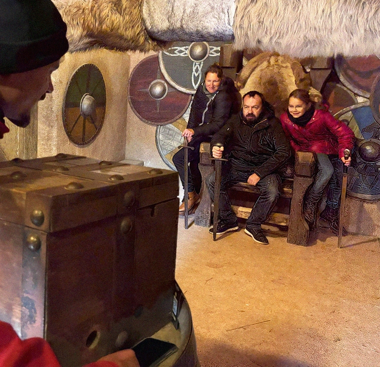 Family enjoying a themed photo shoot at Puy du Fou, with immersive Viking background.