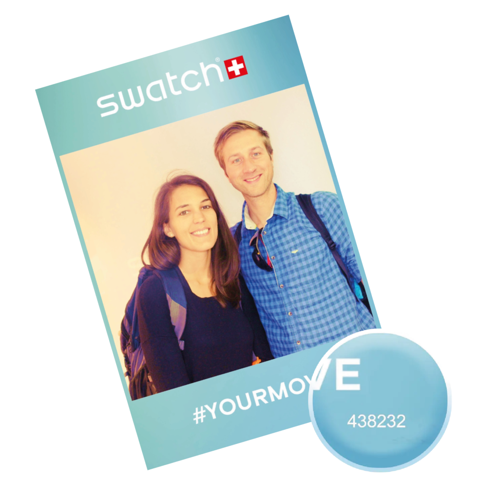 Photograph of a smiling couple holding a Swatch branded photo printout with the hashtag #YOURMOVE.