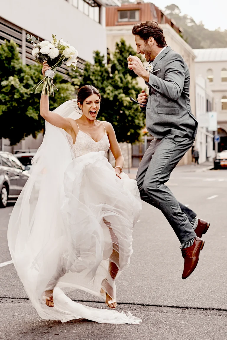 Man and woman wife jumping in the sky on the day of their wedding