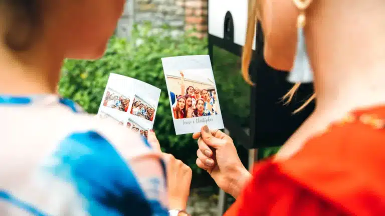 Two persons looking at the picture they are holding in their hands